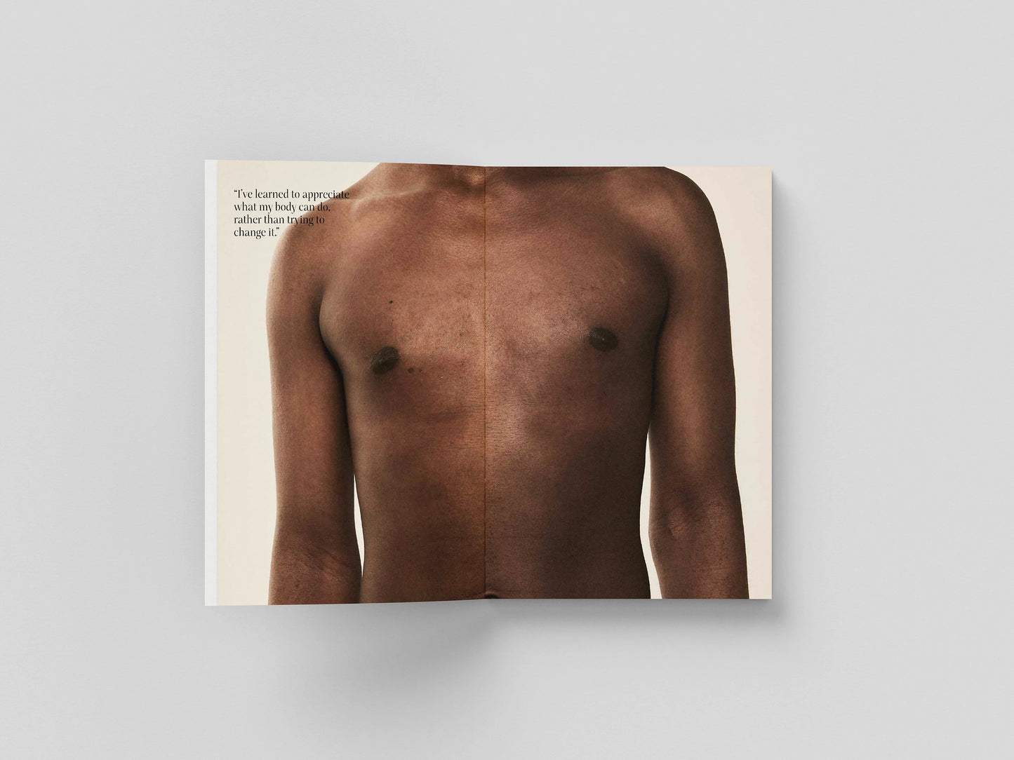 The Chests book open to a full-bleed portrait of a bare chest