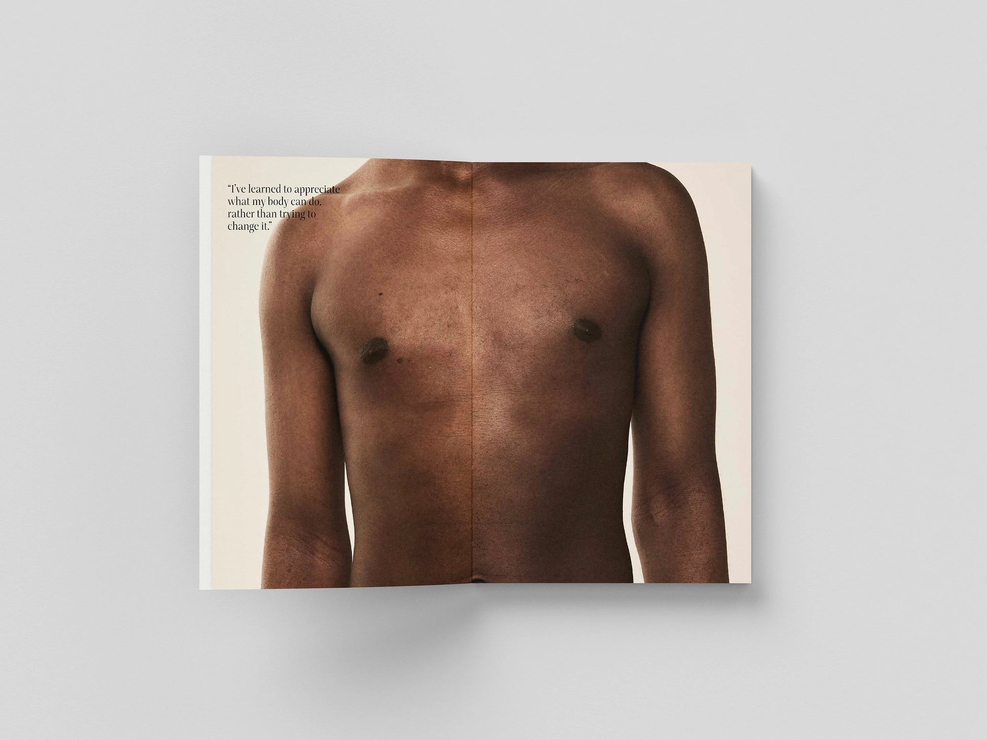 The Chests book open to a full-bleed portrait of a bare chest